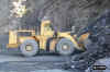 Front-end loader moving rock to the crusher. 