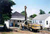 A house being stabilized by pumping fly ash grout into the mine void below.