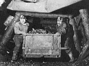 Miners pushing coal car